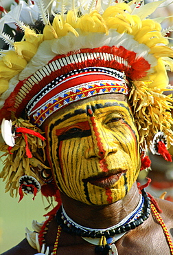 Native man with face paint at a Sing Sing tribal gathering, Papua New Guinea