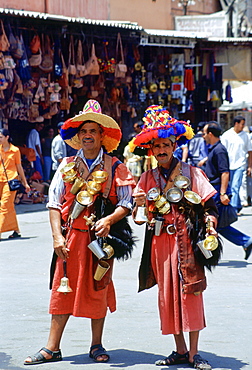 Water sellers in brightly coloured costumes in the Djemma El Fna square in Marrakesh, Morocco