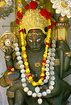 Religious statue adorned with garlands in Kathmandu, Nepal