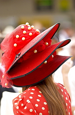 Race-goer in true Ascot fashion wearing a matching spotted dress and three tiered hat at Royal Ascot Races