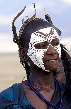 Young recently circumcised Masai Warrior (moran) with traditional face paint after 'coming of age'  in the Serengei Plains, Tanzania