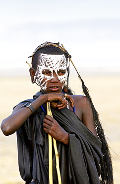 Young recently circumcised Masai Warrior (moran) with traditional face paint after 'coming of age'  in the Serengei Plains, Tanzania