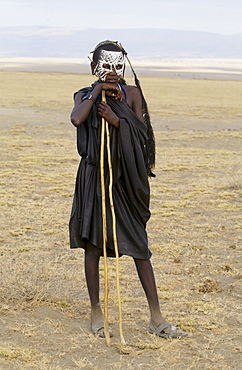 Young Masai recently cirumsised wears white make-up markings and black robes until in a few weeks he adopts the full red colourful robes of a Masai Warrior