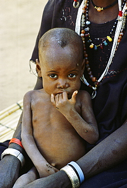 Young child with its mother in Burkina Faso, formerly Upper Volta, Africa.