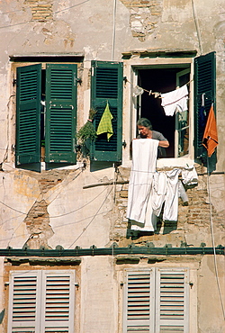 A woman hanging out washing in Corfu.