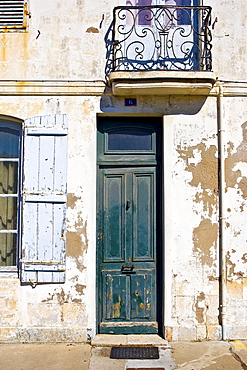 Traditional door on a run-down exterior, Ile De Re, France.