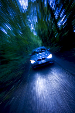 BMW car on country road in the dark, Gloucestershire, United Kingdom