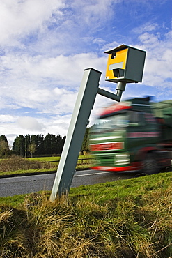 Traffic passes vandalised Gatso speed camera unable to function on A40 road, Oxfordshire, England, United Kingdom