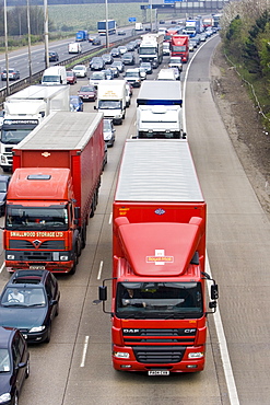 Royal Mail lorry travelling slowly among heavily congested traffic on M1 motorway in Hertfordshire, United Kingdom