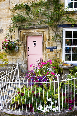 Cotswolds cottage and fenced front garden, Burford, Oxfordshire, UK