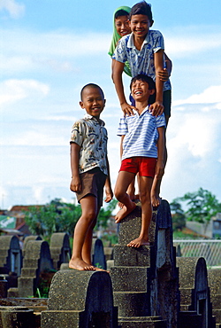 Young boys playing in a cemetery in Jakarta