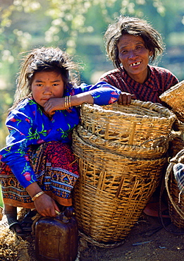 A mother & daughter awaiting a bus to take them to the local market ,  Nepal