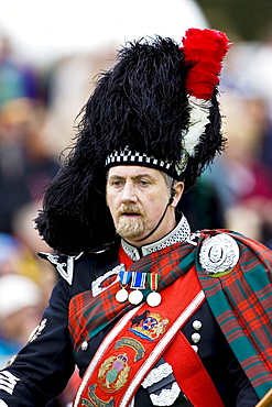 Drum Major of massed band of Scottish pipers at Braemar Games Highland Gathering, Scotland