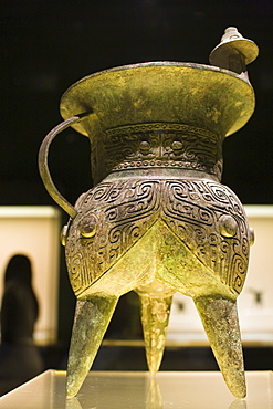 Bronze wine vessel in the shape of an animal mask, on display in glass case at the Shanghai Museum, China