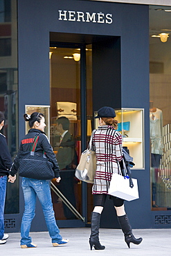 People outside Hermes deisgner clothes shop, on Nanjing Road, central Shanghai, China