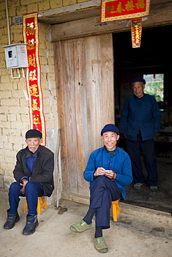 Elderly men sit together in Fuli Old Town, Xingping, China