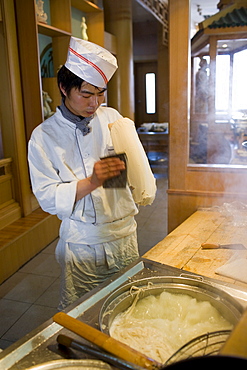 Chef cooking noodles in tourist restaurant, Xian, China