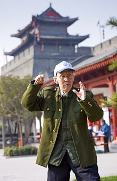 Man practises Tai chi as part of his morning exercise in the park by the City Wall of Xian, China