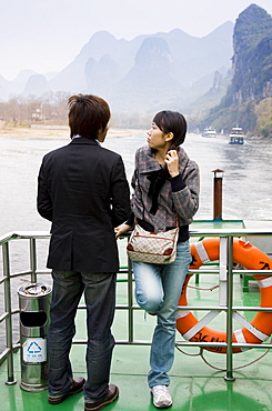 Tourists travel by boat along Li River between Guilin and Yangshuo, China