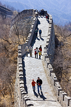 Tourists walk the ancient Great Wall of China at Mutianyu, north of Beijing (formerly Peking), China