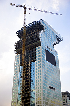 Modern glass skyscraper being built at Olympic site in Beijing, China