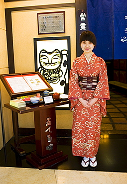 Hostess stands at the entrance of Gonin Byakusho Japanese Restaurant in the Beijing Hotel, China