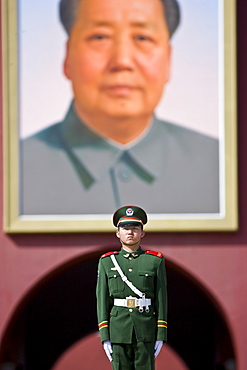 Soldier stands infront of Chairman Mao's portrait at Gate of Heavenly Peace, Entrance to the Forbidden City, China