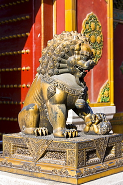 Gilded female lion statue with lion cub under paw in the Forbidden City, Beijing, China