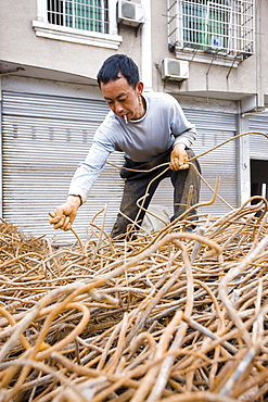 Man working at metal recycling steel in Dazu County, Chongqing, China