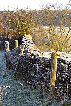 Hoar frost on barbed wire fence and dry-stone wall, Oxfordshire, England, United Kingdom