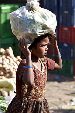 Young girl carrying food in Old Delhi at Daryagang market, India