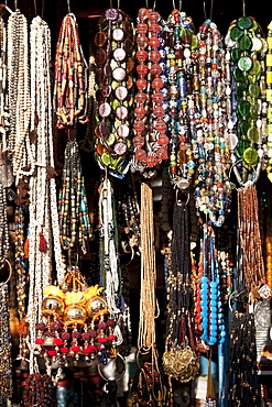 Beads and necklaces on market stall in street scene in city of Varanasi, Benares, Northern India