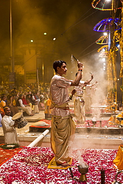 Hindu priests at sundown Aarti Ritual Ceremony of Light during Shivrati Festival in Holy City of Varanasi, Benares, India