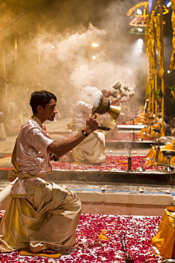 Hindu priests at sundown Aarti Ritual Ceremony of Light during Shivrati Festival in Holy City of Varanasi, Benares, India