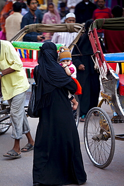 Muslim woman and child out shopping in city of Varanasi, Benares, Northern India