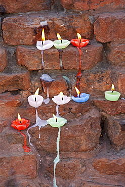 Lighted candles offering Buddhist prayers at Dharmarajika Stupa at Sarnath near Varanasi, Northern India