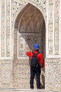 Tourist at Tomb of Etimad Ud Doulah, 17th Century Mughal tomb built 1628, Agra, India