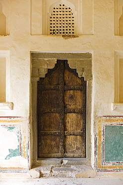 Hindu style traditional door in Acacia wood at the 16th Century Amber Fort in Jaipur in Rajasthan, Northern India