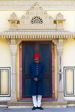 Palace guard in achkan suit at former Royal Guest House now a textile museum in the Maharaja's Moon Palace in Jaipur, Rajasthan, India