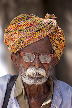 Indian man, the local barber, in typical Rajasthani village of Nimaj, Rajasthan, Northern India