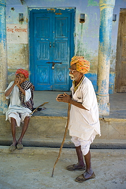 Indian men, one smoking tobacco from Chillam clay pipe, in Rajasthani turbans in Nimaj village, Rajasthan, Northern India