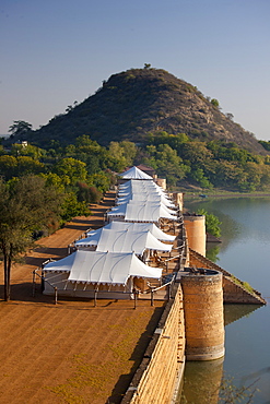 Chhatra Sagar reservoir and luxury tented camp oasis in the desert at Nimaj, Rajasthan, Northern India