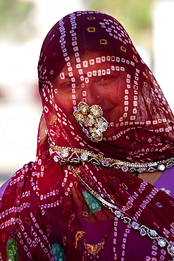 Pretty young Indian woman modestly veiled in Narlai village in Rajasthan, Northern India