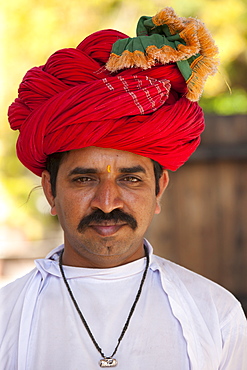 Young Indian man with traditional Rajasthani turban in Narlai village in Rajasthan, Northern India