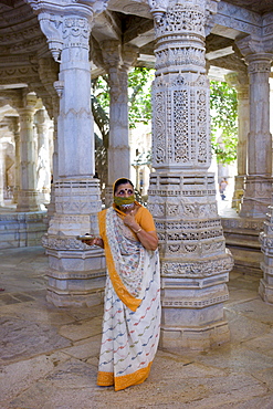 Jain pilgrim with traditional mask at The Ranakpur Jain Temple at Desuri Tehsil in Pali District, Rajasthan, India