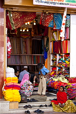 Indian family shopping for children's clothes in old town in Udaipur, Rajasthan, Western India