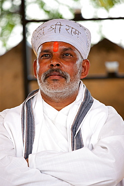 Hindu priest at Holi festival of 76th Maharana of Mewar, Shriji Arvind Singh Mewar of Udaipur, at the City Palace, Rajasthan, India