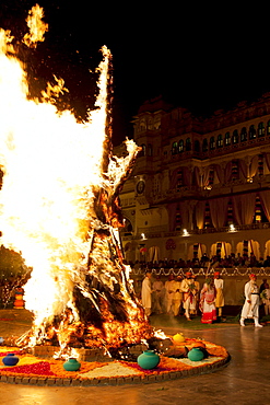 Shriji Arvind Singh Mewar of Udaipur, 76th Custodian of the House of Mewar, presides at annual Hindu Holi Fire Festival at The Zenana Mahal in the City Palace, Udaipur, Rajasthan, India. With him is wife  Maharani Vijaya Laxmi and son  and heir Lakshyaraj Singh Mewar of Udaipur, Maharaj Kumar