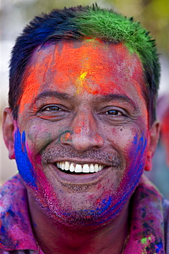 Indian man celebrating annual Hindu Holi festival of colours with powder paints in Mumbai, formerly Bombay, Maharashtra, India