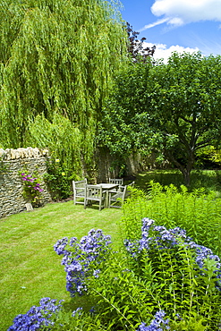 English cottage garden in Swinbrook in The Cotswolds, Oxfordshire, UK